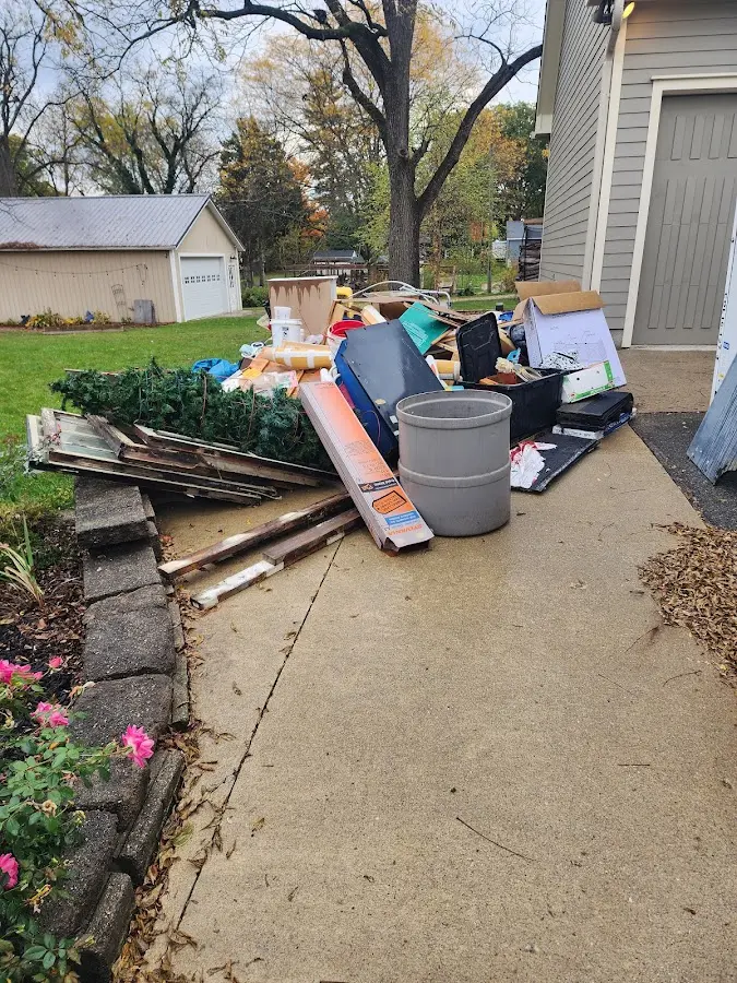 Dumpster being loaded with debris for Estate Cleanout Dumpster Rental in Gluckstadt